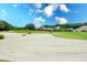 Sand trap and green on a beautiful golf course with homes in the background at 811 Fairwaycove Ln # 107, Bradenton, FL 34212