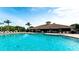 Resort-style community pool with lounge chairs and clubhouse in background at 811 Fairwaycove Ln # 107, Bradenton, FL 34212