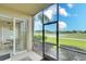 Screened porch with view of the golf course and dining area at 811 Fairwaycove Ln # 107, Bradenton, FL 34212
