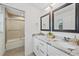 Double vanity bathroom with marble countertop and shower at 1807 Robinhood St, Sarasota, FL 34231