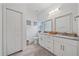 Clean bathroom with double vanity, granite countertop, and neutral tile flooring at 1807 Robinhood St, Sarasota, FL 34231