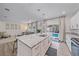 Spacious kitchen with island, stainless steel appliances, and access to the pool at 1807 Robinhood St, Sarasota, FL 34231
