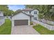 Modern two-story house with a brown garage door and white fence at 1807 Robinhood St, Sarasota, FL 34231