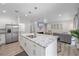 Open concept kitchen with large island, stainless steel appliances, and view to living room at 1807 Robinhood St, Sarasota, FL 34231