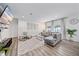 Bright and airy living room with gray sectional sofa and open floor plan at 1807 Robinhood St, Sarasota, FL 34231