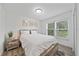 Bright bedroom with a queen-size bed and wood-like flooring at 1807 Robinhood St, Sarasota, FL 34231