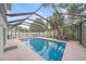 Inviting pool area with covered patio, comfortable seating, and lush landscaping at 1807 Robinhood St, Sarasota, FL 34231