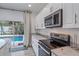 Modern kitchen with stainless steel appliances and granite countertops at 1807 Robinhood St, Sarasota, FL 34231