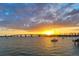 Stunning sunset over the water with a bridge and sailboat in the background at 1221 N Palm Ave # 305, Sarasota, FL 34236