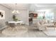 Modern dining room with an open layout to the kitchen and living room at 11406 Belvedere Ter, Lakewood Ranch, FL 34211