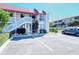 Exterior view of a two-story residential building with parking in front at 1801 Gulf N Dr # 275, Bradenton Beach, FL 34217