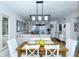 Bright dining area with a farmhouse table and white chairs, open to living room at 1801 Gulf N Dr # 275, Bradenton Beach, FL 34217