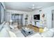 Bright living room with comfy seating, large TV, and access to a balcony at 1801 Gulf N Dr # 275, Bradenton Beach, FL 34217