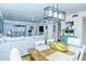 Open concept living and dining area with a farmhouse dining table and white chairs at 1801 Gulf N Dr # 275, Bradenton Beach, FL 34217