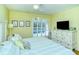 Spacious bedroom with a king-size bed, white dresser, and access to patio at 1801 Gulf N Dr # 275, Bradenton Beach, FL 34217