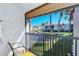 Balcony overlooking a tranquil canal with lush landscaping and residential buildings at 1801 Gulf N Dr # 275, Bradenton Beach, FL 34217