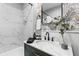 Modern bathroom vanity with marble countertop, stylish mirror and decorative leafy wallpaper at 807 E Genesee St, Tampa, FL 33603