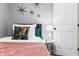 Modern bedroom featuring a stylish bed, a white door and decorative stars on the wall at 807 E Genesee St, Tampa, FL 33603