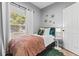Cozy bedroom featuring natural light, window, stylish decor and side table with lamp at 807 E Genesee St, Tampa, FL 33603