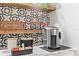 Close up of an inviting in-home coffee bar area with rustic wood shelves and elegant geometric tile backsplash at 807 E Genesee St, Tampa, FL 33603