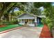 Charming home with a yellow front door, awnings, and well-manicured landscaping at 807 E Genesee St, Tampa, FL 33603