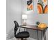 Office featuring a desk, rolling chair, lamp, desk organizer, and wall art at 807 E Genesee St, Tampa, FL 33603