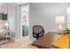 View of the desk in the office, and through the door to the bedroom and bath at 807 E Genesee St, Tampa, FL 33603