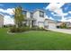 Two-story house with a landscaped lawn, two-car garage, and a welcoming front porch at 404 158Th E St, Bradenton, FL 34212