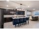 Modern kitchen with dark cabinetry, granite countertops, and a spacious island at 404 158Th E St, Bradenton, FL 34212