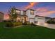 Two-story house with a three-car garage and landscaped yard at 404 158Th E St, Bradenton, FL 34212