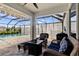 Relaxing pool area with covered patio and seating at 404 158Th E St, Bradenton, FL 34212