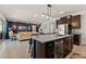 Open concept kitchen with island and view into living room at 404 158Th E St, Bradenton, FL 34212