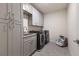 Bright laundry room with ample cabinet space and a utility sink at 404 158Th E St, Bradenton, FL 34212