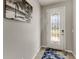 Bright entryway with a glass front door and beach-themed art at 404 158Th E St, Bradenton, FL 34212