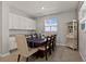 Dining room with white cabinets, granite countertops, and a wooden table at 404 158Th E St, Bradenton, FL 34212