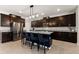 Modern kitchen with dark cabinets, granite countertops and island with seating at 404 158Th E St, Bradenton, FL 34212