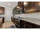 Modern kitchen with dark cabinets and granite countertops at 404 158Th E St, Bradenton, FL 34212