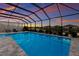 Inviting swimming pool with a screened enclosure and sunset views at 404 158Th E St, Bradenton, FL 34212