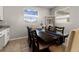Bright dining room features a spacious table with seating for six and a view to the backyard at 404 158Th E St, Bradenton, FL 34212