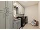 Laundry room with modern washer and dryer, granite countertop, and cabinets at 404 158Th E St, Bradenton, FL 34212