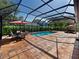 Relaxing screened pool and patio area with seating at 2633 Marlette St, Sarasota, FL 34231