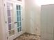 Bedroom with double doors, closet, and neutral carpeting at 4020 Murdock Ave, Sarasota, FL 34231