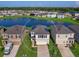 Aerial view of a two-story house with solar panels, a two-car garage and a landscaped yard at 2966 Great Abaco Way, Bradenton, FL 34208