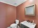 Small bathroom with updated vanity, toilet and a terracotta colored wall at 2966 Great Abaco Way, Bradenton, FL 34208