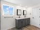 Bathroom with double vanity and a window with a view at 2966 Great Abaco Way, Bradenton, FL 34208
