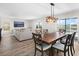 Bright dining room featuring a wooden table with six chairs, hardwood floors and a view to the backyard pool at 2966 Great Abaco Way, Bradenton, FL 34208