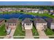 Aerial view of a two-story house with solar panels, a two-car garage and a landscaped yard at 2966 Great Abaco Way, Bradenton, FL 34208