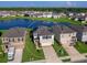 Aerial view of a two-story house with solar panels, a two-car garage and a landscaped yard at 2966 Great Abaco Way, Bradenton, FL 34208