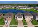 Aerial view of a two-story house with solar panels, a two-car garage and a landscaped yard at 2966 Great Abaco Way, Bradenton, FL 34208