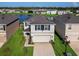 Two-story house with a two-car garage and solar panels on the roof at 2966 Great Abaco Way, Bradenton, FL 34208